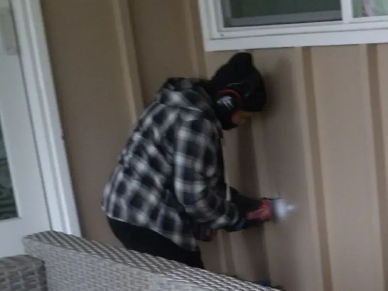 Professional electrician installing an exterior outlet in Stanford